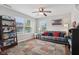 Cozy living room with a sofa, decorative pillows, a ceiling fan, and large windows at 3430 Burlingame Blvd, Westfield, IN 46074