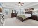 Primary bedroom with tray ceiling, carpeted floor, windows, and wood furnishings at 3430 Burlingame Blvd, Westfield, IN 46074