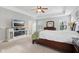 Bright main bedroom features a decorative ceiling fan, large windows, dresser, and a bed at 3430 Burlingame Blvd, Westfield, IN 46074