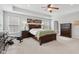 Primary bedroom with tray ceiling, carpeted floor, windows, and wood furnishings at 3430 Burlingame Blvd, Westfield, IN 46074
