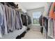 Spacious walk-in closet with metal shelving, hanging racks, carpet, and a window for natural light at 3430 Burlingame Blvd, Westfield, IN 46074