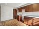 Spacious kitchen featuring wooden cabinets, laminate countertops, and wood-look flooring at 3511 N Keystone Ave, Indianapolis, IN 46218
