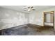 Spacious living room featuring carpet and a ceiling fan awaiting personal touches and updates at 3511 N Keystone Ave, Indianapolis, IN 46218