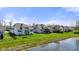 Beautiful backyard featuring a well-manicured lawn, pond, and neighboring houses in a Gathering-friendly community at 3678 Sugar Pine Ln, Zionsville, IN 46077