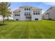 Expansive backyard with healthy green grass, showcasing the home's rear with multiple windows and a small deck at 3678 Sugar Pine Ln, Zionsville, IN 46077