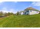 Green lawn with a pond and homes in the distance, showing a peaceful backyard view at 3678 Sugar Pine Ln, Zionsville, IN 46077