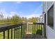 Balcony features wood decking and railing with scenic water view, perfect for outdoor relaxation and entertainment at 3678 Sugar Pine Ln, Zionsville, IN 46077