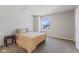 Bedroom with window features neutral walls, carpet, ample natural light and a dark wood accent table at 3678 Sugar Pine Ln, Zionsville, IN 46077