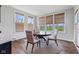Bright breakfast nook features wood floors, a round table with four chairs, and three large windows with woven blinds at 3678 Sugar Pine Ln, Zionsville, IN 46077