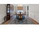 Formal dining room featuring hardwood floors, a large area rug, and elegant furnishings at 3678 Sugar Pine Ln, Zionsville, IN 46077