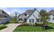 Beautiful home with lush green lawn, stone accents, blue shutters, and mature landscaping at 3678 Sugar Pine Ln, Zionsville, IN 46077