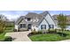 Charming home with stone accents, blue shutters, a well-manicured lawn, and an attached garage at 3678 Sugar Pine Ln, Zionsville, IN 46077