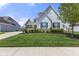 Picturesque home with stone accents, blue shutters, lush lawn and manicured landscape at 3678 Sugar Pine Ln, Zionsville, IN 46077