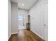 Bright hallway featuring hardwood floors, a coat rack, and an open view of the laundry room at 3678 Sugar Pine Ln, Zionsville, IN 46077