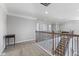 Hallway features neutral carpet, contemporary lighting and wrought iron railing offering a seamless flow at 3678 Sugar Pine Ln, Zionsville, IN 46077