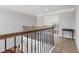 Hallway boasting detailed wrought iron railing and neutral color palette, leading to additional rooms at 3678 Sugar Pine Ln, Zionsville, IN 46077