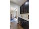 Kitchen with granite countertops, dark cabinets, beverage cooler, and access to the dining room at 3678 Sugar Pine Ln, Zionsville, IN 46077