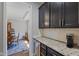 Kitchen with dark cabinets, granite countertops, beverage cooler, and access to the dining room at 3678 Sugar Pine Ln, Zionsville, IN 46077