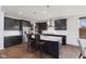 Modern kitchen with dark cabinetry, granite countertops, stainless steel appliances, and island seating at 3678 Sugar Pine Ln, Zionsville, IN 46077