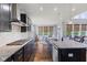 Well-designed kitchen with island seating, granite countertops, and a view of the breakfast nook at 3678 Sugar Pine Ln, Zionsville, IN 46077