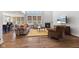 Bright living room boasts a fireplace, hardwood floors, and abundant natural light from large windows at 3678 Sugar Pine Ln, Zionsville, IN 46077