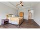 Bright main bedroom offers a ceiling fan, dark wood floors, bedside tables, and an ensuite bathroom at 3678 Sugar Pine Ln, Zionsville, IN 46077