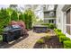 Relaxing backyard features a hot tub, privacy landscaping, a grill, and a brick paver patio, perfect for outdoor enjoyment at 440 E 82Nd St, Indianapolis, IN 46240