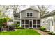 A spacious backyard with a well-manicured lawn, stone fire pit, and an outdoor seating area at 440 E 82Nd St, Indianapolis, IN 46240