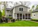 The backyard with a stone fire pit, outdoor seating, and manicured lawn, perfect for relaxing at 440 E 82Nd St, Indianapolis, IN 46240