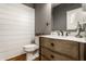 Stylish bathroom with wood vanity and shiplap walls at 440 E 82Nd St, Indianapolis, IN 46240