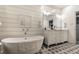 Elegant bathroom with a soaking tub, stylish vanity, and patterned tile flooring for a luxurious feel at 440 E 82Nd St, Indianapolis, IN 46240