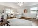 Airy bedroom with hardwood floors, neutral paint, and a plush white rug, creating a calm and inviting atmosphere at 440 E 82Nd St, Indianapolis, IN 46240