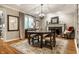 Elegant dining room features wood floors, chandelier, fireplace, and natural light at 440 E 82Nd St, Indianapolis, IN 46240