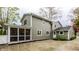 Exterior view of the home showcasing the screened-in porch and patio area in a fenced backyard at 440 E 82Nd St, Indianapolis, IN 46240