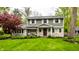Beautiful two-story home with stone accents, lush lawn, and mature landscaping at 440 E 82Nd St, Indianapolis, IN 46240