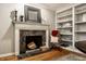 Cozy fireplace with marble surround, mantel decor, and built-in shelves at 440 E 82Nd St, Indianapolis, IN 46240