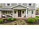 Cozy front porch with seating, stone details, and manicured landscaping at 440 E 82Nd St, Indianapolis, IN 46240