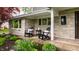 Charming porch with Adirondack chairs and a view of the landscaped front yard at 440 E 82Nd St, Indianapolis, IN 46240