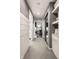 Bright hallway features carpet, grey walls, and storage shelves leading to the main bedroom and the bathroom at 440 E 82Nd St, Indianapolis, IN 46240