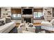 Cozy living room with a stone fireplace, built-in benches, and hardwood floors at 440 E 82Nd St, Indianapolis, IN 46240