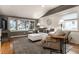 Bright living room with large windows, white shiplap walls, and hardwood floors at 440 E 82Nd St, Indianapolis, IN 46240