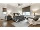 Cozy main bedroom featuring a ceiling fan, two windows, and hardwood floors with a neutral area rug at 440 E 82Nd St, Indianapolis, IN 46240