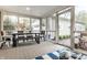 Screened porch with dining table and bench seating, offering an ideal space for outdoor relaxation and entertaining at 440 E 82Nd St, Indianapolis, IN 46240