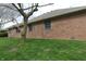 A brick house exterior showing the side of the home with multiple windows and green grass at 4652 Kensington N Way, Plainfield, IN 46168