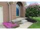 Close up of the blue front door entrance with a beautiful flowering tree and lovely pink flower bed at 4652 Kensington N Way, Plainfield, IN 46168