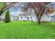 Charming backyard featuring a well-maintained lawn, mature trees, and cozy outdoor seating area at 473 N 17Th St, Noblesville, IN 46060