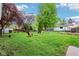 Lush backyard featuring a fire pit, mature trees, and a well-maintained lawn at 473 N 17Th St, Noblesville, IN 46060