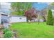 Serene backyard with lush green grass, inviting chairs, and a detached garage at 473 N 17Th St, Noblesville, IN 46060