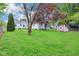 Large backyard view featuring a red shed and well-maintained lawn, offering ample outdoor space at 473 N 17Th St, Noblesville, IN 46060