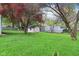 Spacious backyard featuring a quaint shed, mature trees, and a well-maintained lawn at 473 N 17Th St, Noblesville, IN 46060